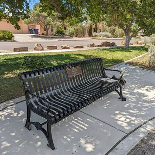 Memorial bench with a book and chimes