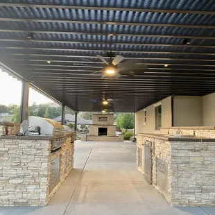 A 1300 sq. ft. pergola, a barbecue &amp; bar island and, an outdoor fireplace in the distance.