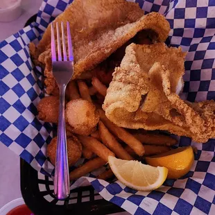 a basket of fried fish and fries