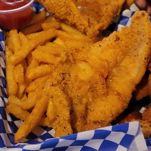 a basket of fried fish and fries