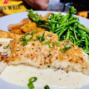 Tilapia  in a white cream sauce, potatoes, and broccoli. So good!
