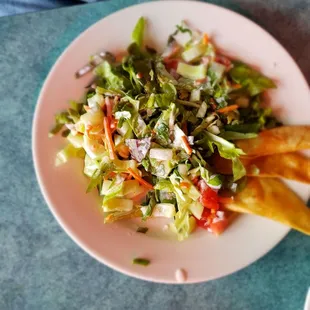 Fresh picked leafy greens, cucumbers, and tomatoes