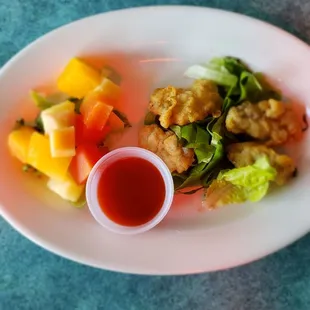 Appetizer with fresh oysters and fresh fruit.
