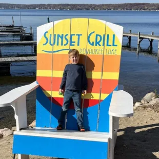 a young boy sitting on a chair