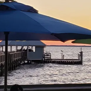 a view of a dock at sunset