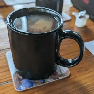 a cup of coffee on a coaster