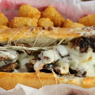 a cheeseburger sandwich with tater tots