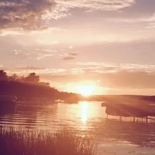 the sun setting over the water