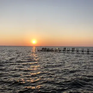 people standing on a pier