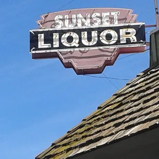 a neon sign for sunset liquor