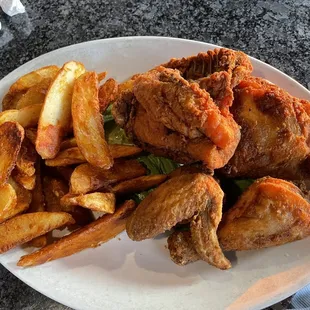 a plate of fried chicken and french fries