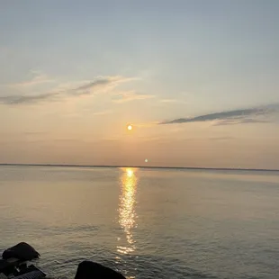 the sun setting over the water
