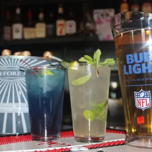 a glass of bud light next to a glass of lemonade