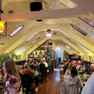 people sitting at tables in a restaurant