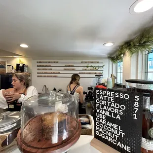 a woman sitting at a counter in a coffee shop