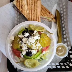 a salad and a sandwich in a basket