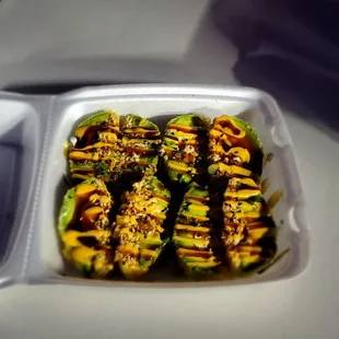 a container of grilled zucchini peppers