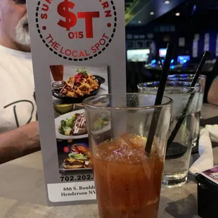 a glass of iced tea and a menu