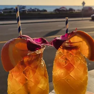 two glasses of orange juice on a table