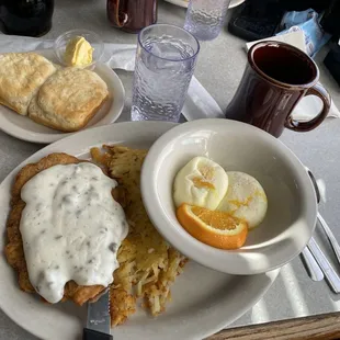 Country Fried Steak and eggs with hash browns and biscuits.