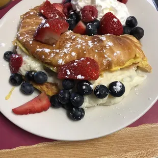 Croissant French Toast stuffed with sweetened cream cheese and topped with mixed berries. Special for the day!