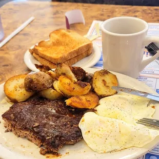 8/13/22 another great breakfast. Chop steak eggs over medium sliced fried potatoes coffee wheat toast.