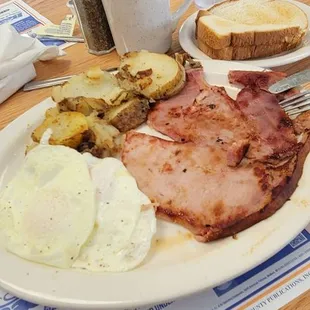 5/8/24 One of my favorites the Giant ham steak and eggs O/E with fried potatoes toast cawfee