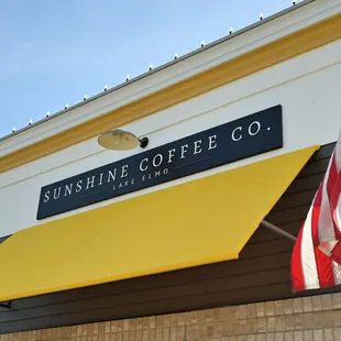 a yellow awning and american flag
