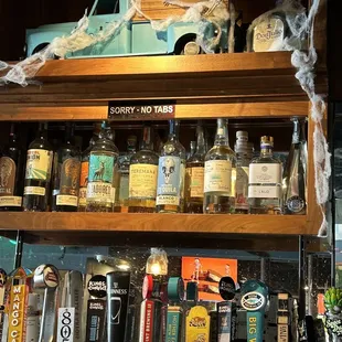 a shelf full of liquor bottles