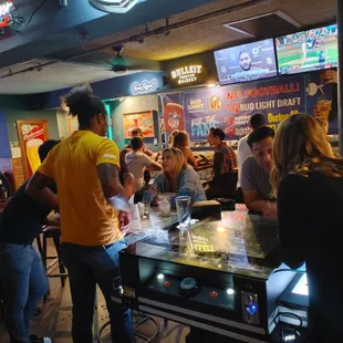 a group of people at a bar