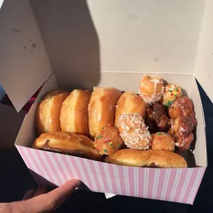a box of donuts with sprinkles