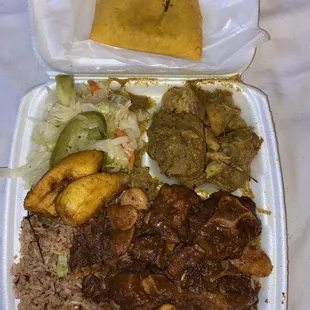 Oxtail, curried chicken, rice and peas, cabbage, and plantains.