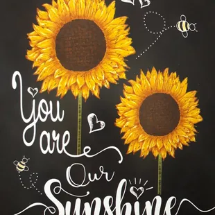 two sunflowers with bees