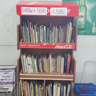 a book shelf with a coca cola sign
