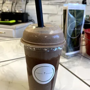 a cup of iced coffee on a counter