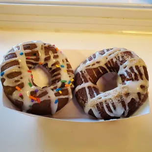 Freshly made donuts - shown birthday cake and cinnamon roll flavors