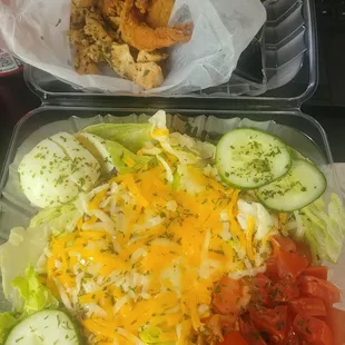 It comes with lettuce, red cabbage, cucumbers, tomatoes, croutons, a boiled egg, and tons of cheese. So, a pretty traditional salad.