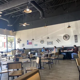 people sitting at tables and eating