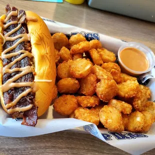 Smokehouse Dog; bacon, Monterey jack, cheddar, chili, Sup Dog sauce. Side of tots and Sup Dog sauce