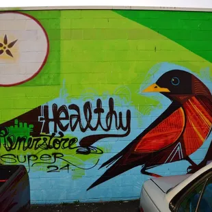 ows a colorful bird painted on a wall