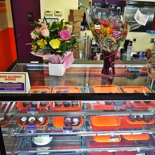 a display of baked goods and flowers