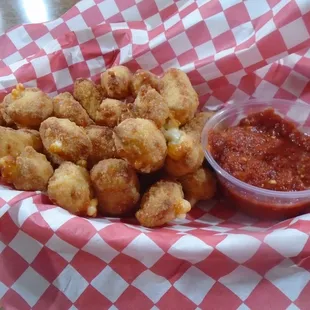 Cheese curds with dipping sauce.