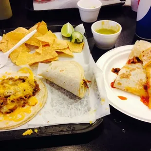 Quesadilla Al Pastor and 2 shredded beef tacos con queso with Salsa Verde.