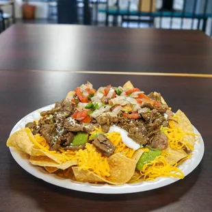 a plate of nachos on a table