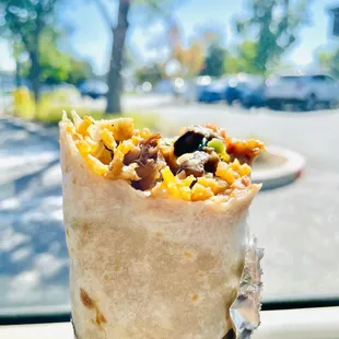 a hand holding a burrito