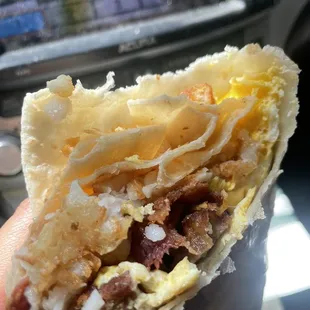 Super breakfast burrito which comes with bacon, sausage, hash brown, eggs, and cheese