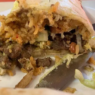 This was so delicious . Carne Asada, lettuce , Tomato , Rice  and French Fries .