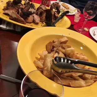 two plates of food and a glass of wine