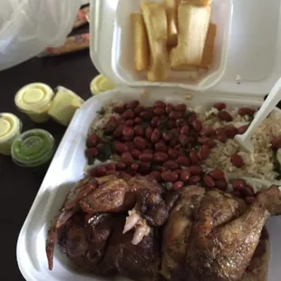 Yum 1/2 chicken combo with rice and beans and a side of yuca fries.