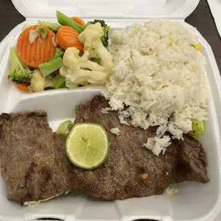 Carne Asada dish with rice and steamed vegetables